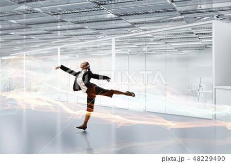 Dancing businesswoman in office Dancing businesswoman in office 48229490