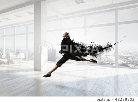 Dancing businesswoman in office 48229502