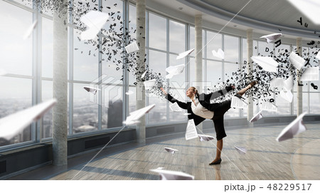 Dancing businesswoman in office 48229517