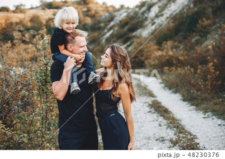 Stylish family in a park Stylish family in a park 48230376