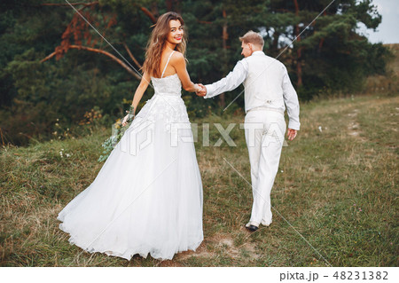 Beautiful wedding couple in a summer field 48231382