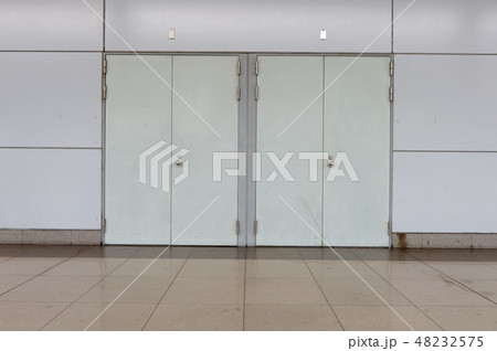 sidewalk by street wall & door sidewalk by street wall & door 48232575