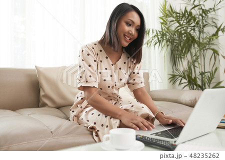 Pretty woman working on laptop 48235262