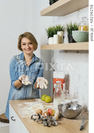 Girl preparing food in kitchen Girl preparing food in kitchen 48236256
