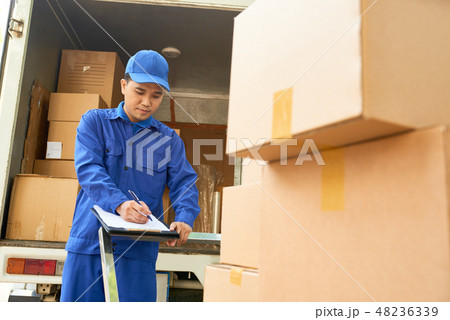 Delivery man loading truck 48236339