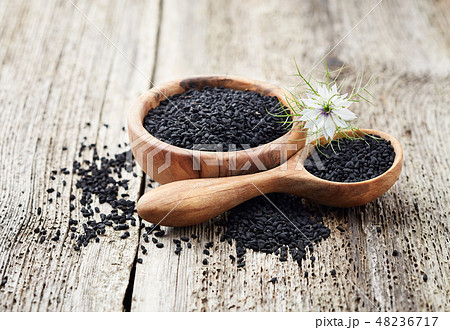 Black cumin oil with flower on wooden board 48236717