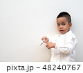sick boy with thermometer on white background 48240767