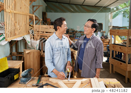 Father and son in garage workshop Father and son in garage workshop 48241182