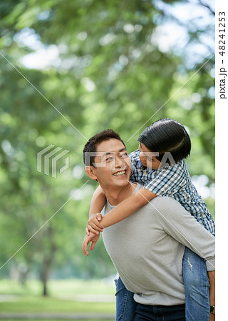 Father giving piggyback ride Father giving piggyback ride 48241253