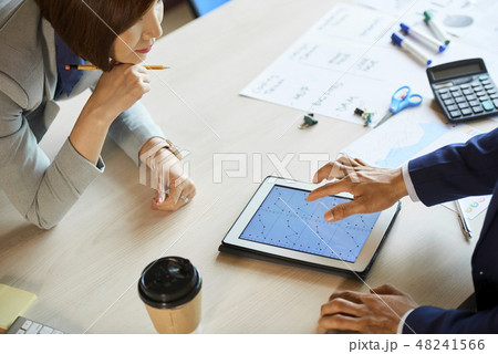 Business executives discussing statistics 48241566