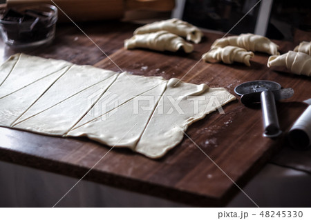 Cut the dough into triangles for croissants with chocolate 48245330