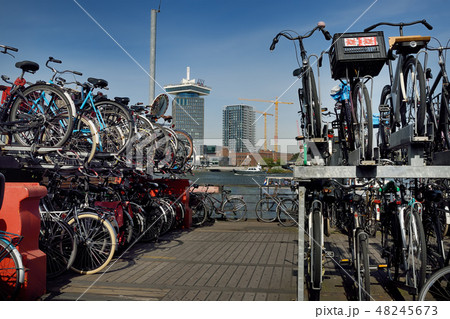 Bike Parking at pier of river in Amsterdam 48245673
