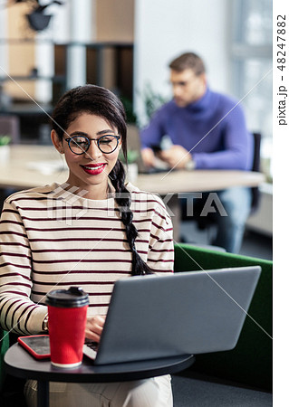 Cute longhaired brunette girl working with pleasure 48247882