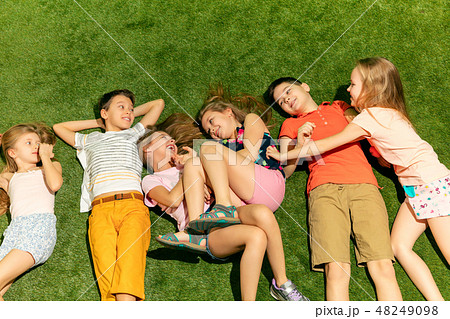 Group of happy children playing outdoors. 48249098