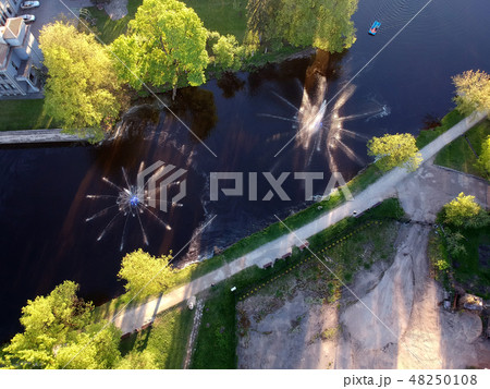 fountains on spring river in park, aerial view 48250108