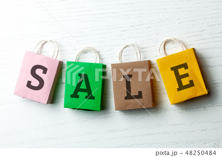 Colored shopping bags with the inscription SALE on white background. Colored shopping bags with the inscription SALE on white background. 48250484