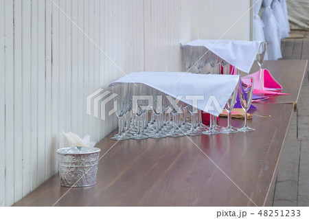 The image of many empty glasses at the champagne ready for a reception under a napkin The image of many empty glasses at the champagne ready for a reception under a napkin 48251233