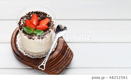 Panna cotta dessert with fresh strawberry on wooden table Panna cotta dessert with fresh strawberry on wooden table 48252561