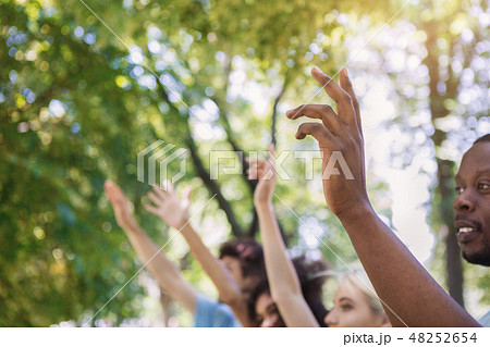 Volunteers voting at group meeting in park Volunteers voting at group meeting in park 48252654