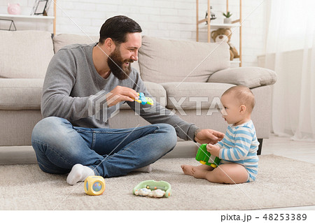 Young father and his baby boy playing with toy car 48253389