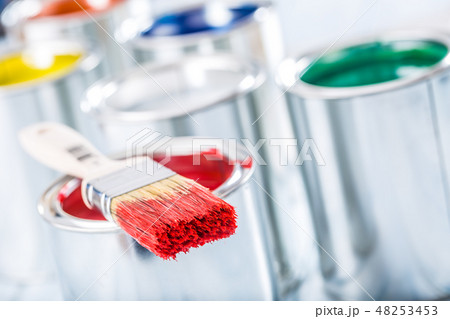 Close-up brush with red color lying on paint can. Close-up brush with red color lying on paint can. 48253453