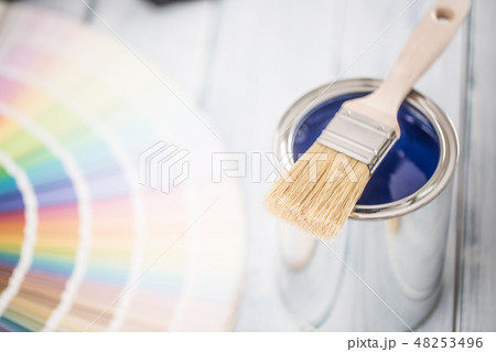 Paint cans brush and color palette on table. 48253496