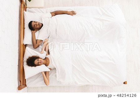 Tired and annoyed woman of her boyfriend snoring 48254126