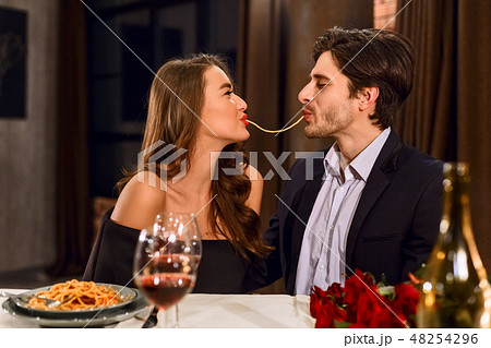 Loving couple eating pasta Loving couple eating pasta 48254296