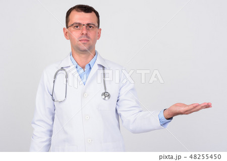 Portrait of man doctor with eyeglasses showing something 48255450