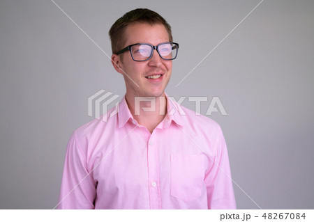 Face of happy young nerd businessman thinking with eyeglasses 48267084