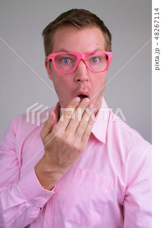 Face of young feminine businessman looking shocked with eyeglasses Face of young feminine businessman looking shocked with eyeglasses 48267114