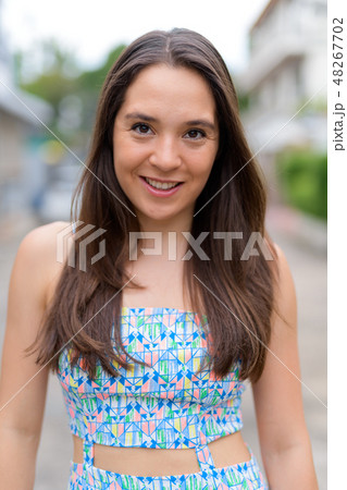 Beautiful happy multi-ethnic woman smiling in the streets outdoors 48267702