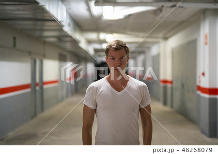 Young Handsome Man Looking At Camera Along The Corridor Young Handsome Man Looking At Camera Along The Corridor 48268079