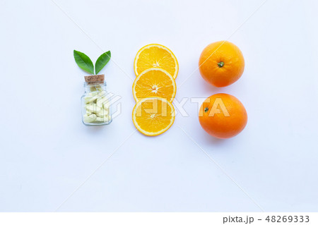 Vitamin C bottle and pills with orange fruit Vitamin C bottle and pills with orange fruit 48269333