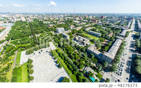 Aerial city view with roads, houses and buildings. Aerial city view with roads, houses and buildings. 48276373