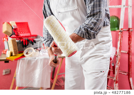 House painter at work on the construction site. 48277186