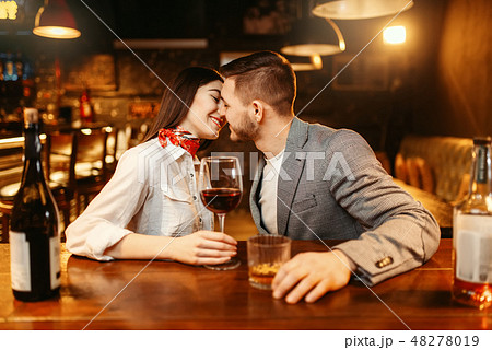 Romantic evening in bar, couple kissing at counter 48278019