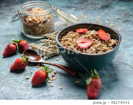 Homemade granola with ripe strawberries 48279541