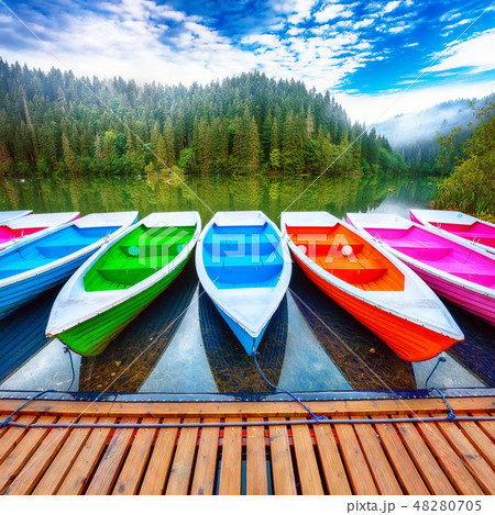 Boats on majestic mountain lake Lacul Rosu 48280705