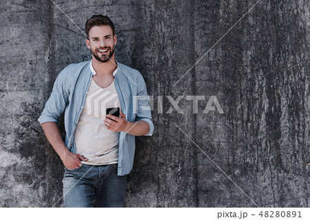 No one succeeds without effort. Sexy brown-haired man with blue eyes standing isolated over grey No one succeeds without effort. Sexy brown-haired man with blue eyes standing isolated over grey 48280891