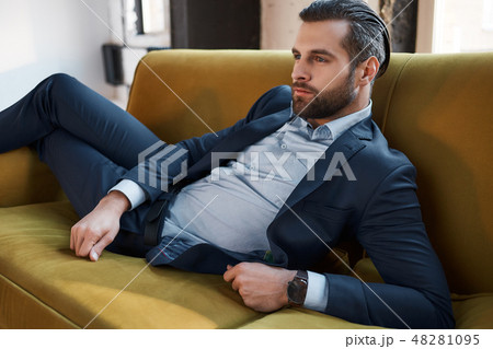 Stylish young man in a suit and bow tie. Business style. Fashionable image. 48281095