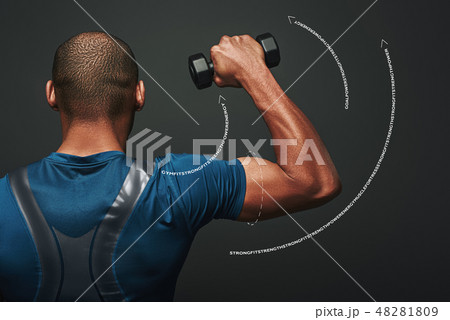 Improve your shape. Dark skinned sportsman working out with dumbbells over dark background Improve your shape. Dark skinned sportsman working out with dumbbells over dark background 48281809