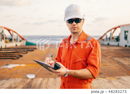 chief officer on deck of ship or vessel with checklist 48283273