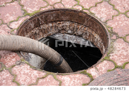 pumping sewage from the drain hole 48284673