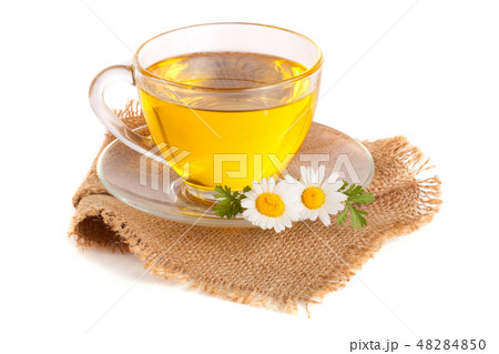 Herbal tea with fresh chamomile flowers on sackcloth isolated on white background 48284850