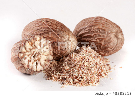 Three nutmeg and powder isolated on white background 48285213