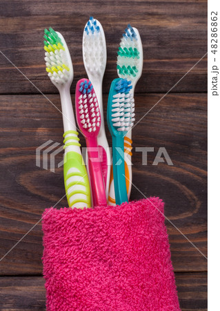 toothbrushes on the black wooden background toothbrushes on the black wooden background 48286862