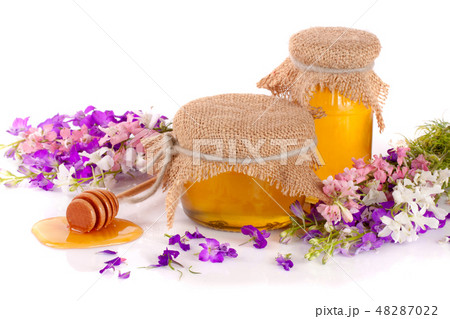 Jar of honey with wildflowers isolated on white background 48287022