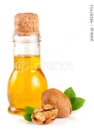 Walnut oil with nuts isolated on a white background Walnut oil with nuts isolated on a white background 48287451