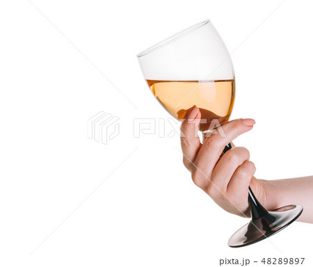 glass of white wine in a female hand glass of white wine in a female hand 48289897